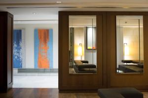 a lobby with two mirrors and two chairs in a room at Hospes Amérigo, Alicante, a Member of Design Hotels in Alicante +37 photos