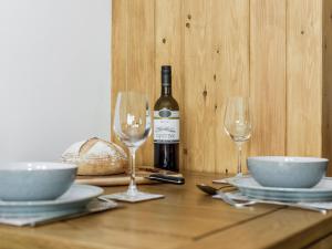 a table with a bottle of wine and two glasses at The Old Hat Factory in Scotforth