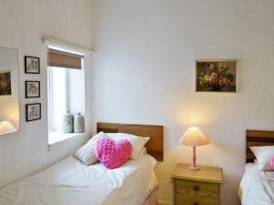 A bed or beds in a room at Beach Cottage 