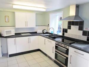 A kitchen or kitchenette at Otter Cottage 