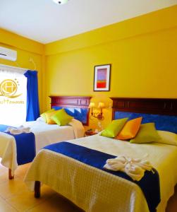 Postel nebo postele na pokoji v ubytování Hotel Las Hamacas