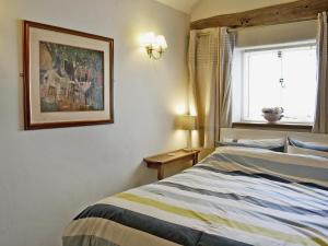 A bed or beds in a room at Cow Shed 