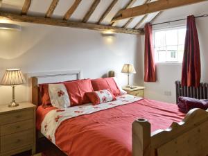 A bed or beds in a room at The Stable 