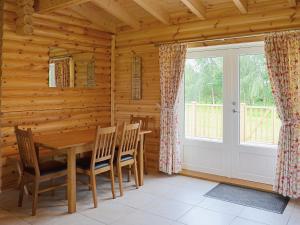 a dining room with a table and chairs and a window at Quail Lodge - W44304 in Burn