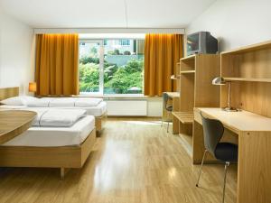 Ένα ή περισσότερα κρεβάτια σε δωμάτιο στο Hotel Edda Akureyri