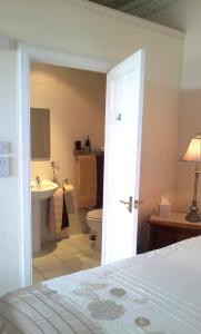 a bathroom with a bed and a sink and a toilet at Gramarcy House in Brechin