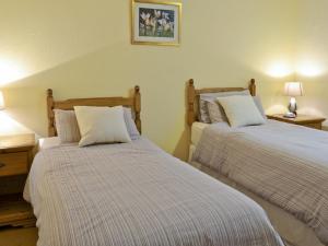 A bed or beds in a room at Old Post Office 