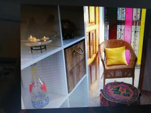 a room with a shelf with a chair and a vase at MAGIC SUN Loft in Candelaria