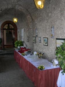 a long table with a red table cloth in a room at Hotel Parsifal - Antico Convento del 1288 in Ravello