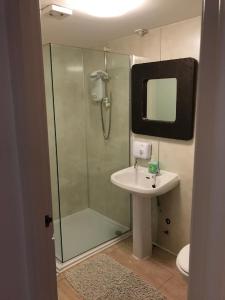 a bathroom with a shower and a sink and a mirror at Serviced Accommodation Moray in Elgin