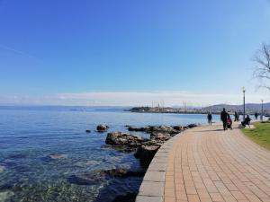 a walkway next to a body of water at Stole Apartment in Izola