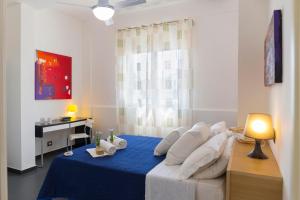 a bedroom with a blue bed with white pillows at Mareinsicilia Cannamara Appartamenti in Donnalucata