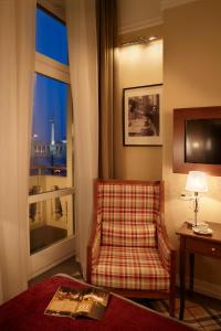 a living room with a chair and a window at Mirage Medic Hotel in Budapest