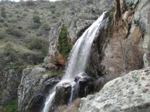 a waterfall on the side of a cliff at Pensión El abuelo in Carbellino