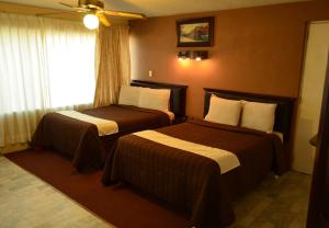Voodi või voodid majutusasutuse Hotel Flamingo Kristal toas
