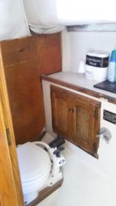 a bathroom with a toilet in a room at Classic Sailboat 30’ in Miami
