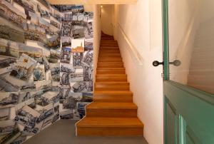 a staircase with a wall of photos on the wall at Apartments Casa Vecchia in Rovinj