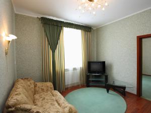 sala de estar con sofá y TV en Paradise Hotel, en Svitlovodsʼk