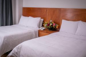 Ένα ή περισσότερα κρεβάτια σε δωμάτιο στο AMD Hotel