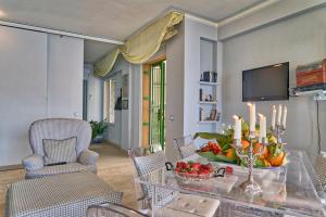 a living room with a table with a bowl of fruit at Luxury Apartment and Charm Sea View Isola Bella in Taormina