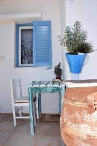 a blue table with a chair and a blue window at Ammos Apartments in Ierápetra +19 photos