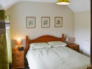 A bed or beds in a room at The Bothy 