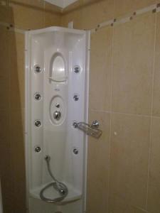 a shower in a bathroom with a glass door at Aiolides Hotel in Kalyvia