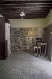 a dining room with a table and a chair at Casa Kastellania in Rhodes Town