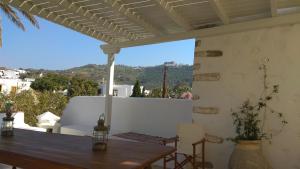 a table and chairs on a patio with a view at En Patmo Holiday Home in Patmos