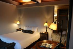 una camera da letto con un letto, un tavolo e una sedia di Timbers Inn a Eugene