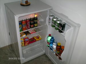 an open refrigerator filled with drinks and soda at b&b il Maggiolino in Vibo Valentia