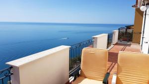 a balcony with chairs and a view of the water at Amalfi Hills in Amalfi