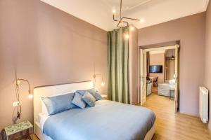 Un dormitorio con una cama grande con almohadas azules. en DOWNTOWN SRL - Cinque Terre New Liberty, en La Spezia