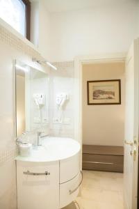 a white bathroom with a sink and a mirror at Venezia Residence in Venice