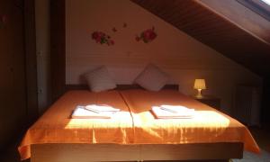 a bedroom with a bed with two towels on it at Sound Apartma Eva in Radovljica