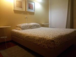 a bedroom with a bed and a lamp at Travelers by Rio NaturAL in Vila Nova de Milfontes