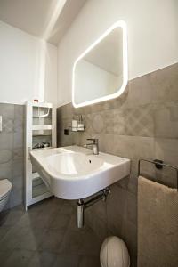 a bathroom with a white sink and a mirror at B&B Acquapazza in Brindisi