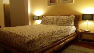 a neatly made bed in a hotel room at Travelers by Rio NaturAL in Vila Nova de Milfontes