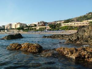 a view of a beach with rocks in the water at Hotel Riviera Bleu in Diamante