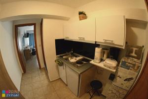 a small kitchen with a sink and a counter at The L Studio in Néa Péramos