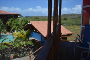 a view from the balcony of a house with a swimming pool at Nos Krusero Apartments in Sabana Westpunt