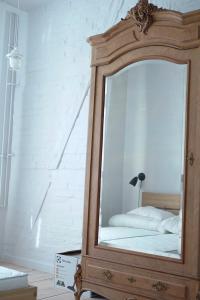 a mirror in a wooden dresser in a room at Apartament Ludowa 1 Międzyzdroje in Międzyzdroje