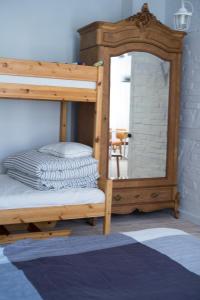 a bedroom with a bunk bed with a mirror at Apartament Ludowa 1 Międzyzdroje in Międzyzdroje