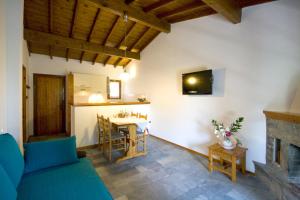 a living room with a couch and a dining room at Villas Alexandra Skiathos in Skiathos