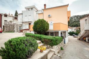 a house with bushes in front of it at Apartmani Sršen in Blace +4 photos