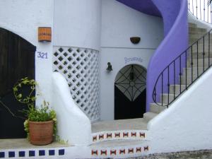 a house with a staircase and a door at Amaranto Bed and Breakfast in Cozumel