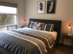 a bedroom with a bed with pillows and a window at Mount Gambier Apartment - 1206 in Mount Gambier