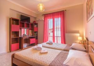 a bedroom with two beds and a window at Fontana Holiday Home in Mouzákion +64 photos