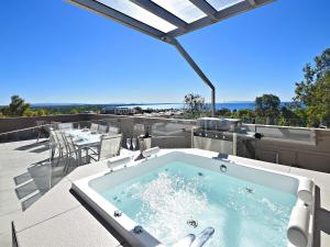 a swimming pool with a pool table and chairs at Picture Point Terraces in Noosa Heads
