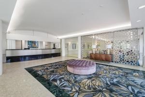 a large room with a rug and a large bed at Central Dockside Apartment Hotel in Brisbane